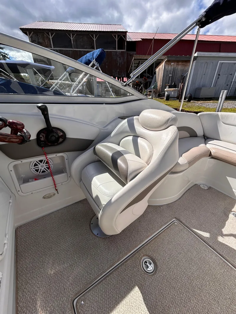 Slide: The Image of 2007 Crownline 255 CCR boat interior with plush seating and control panel. - 22