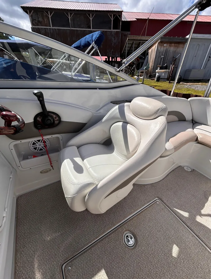 Slide: The Image of 2007 Crownline 255 CCR boat interior with white seating and control panel. - 23