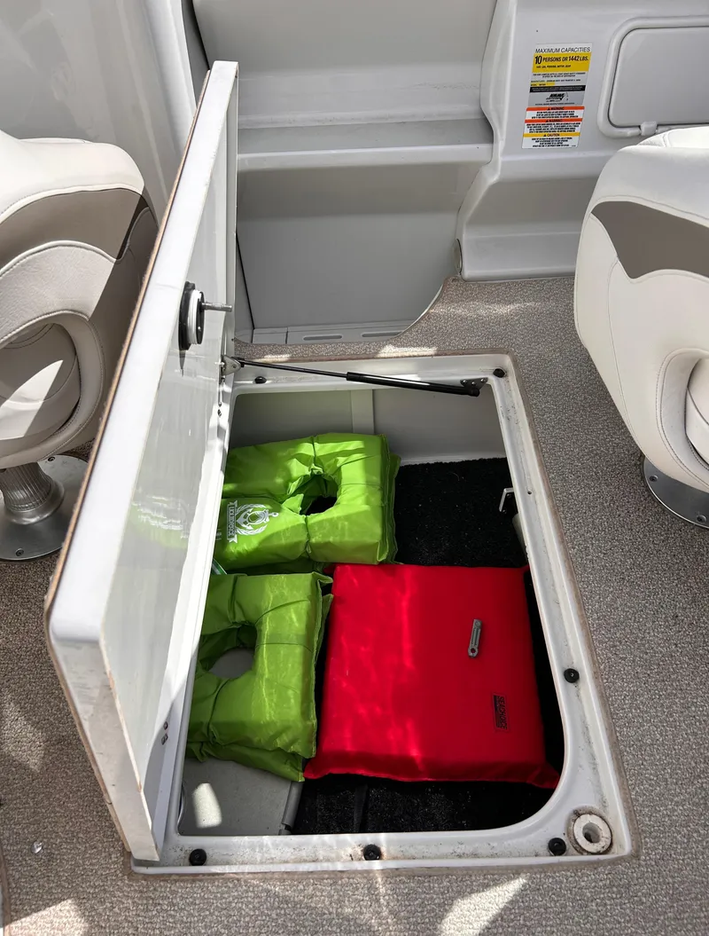 Slide: The Image of 2007 Crownline 255 CCR boat storage compartment with life jackets. - 27