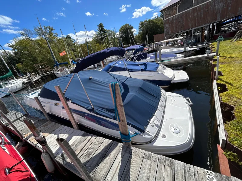 Slide: The Image of 2007 Crownline 255 CCR boat docked at marina under blue sky. - 3