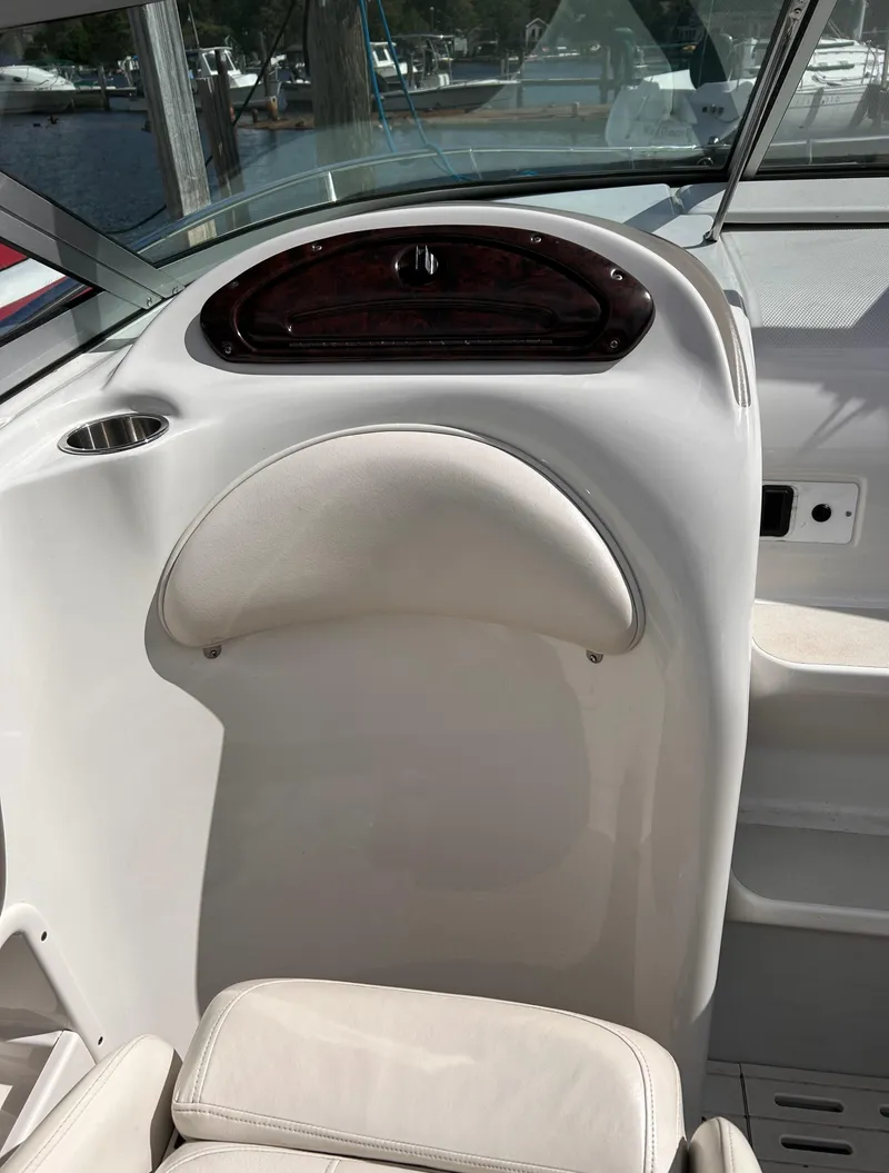 Slide: The Image of 2007 Crownline 255 CCR boat interior with white seating and dashboard. - 30