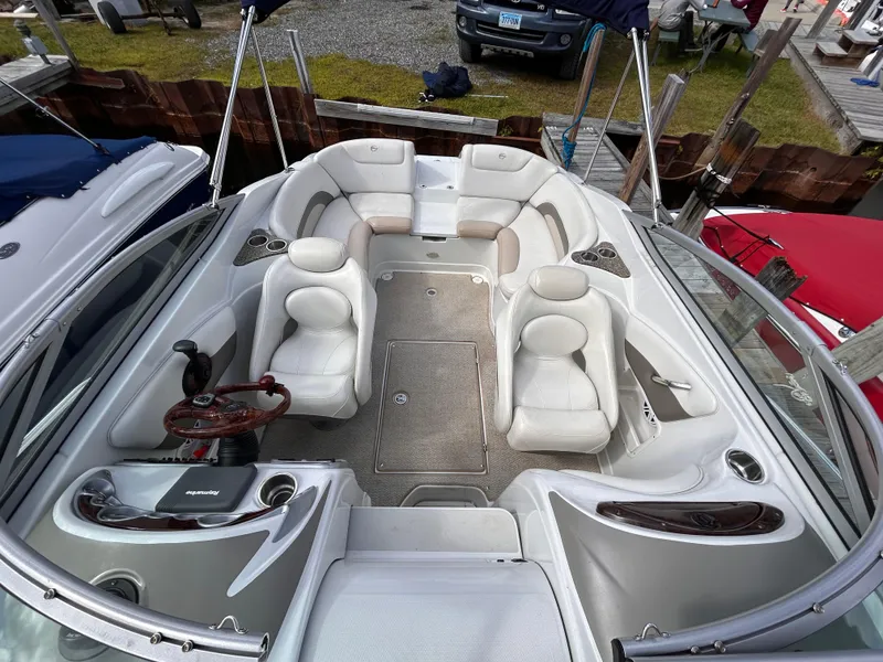 Slide: The Image of 2007 Crownline 255 CCR boat interior with white seating and steering wheel. - 32