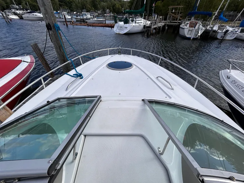 Slide: The Image of 2007 Crownline 255 CCR boat docked at marina, open deck view. - 34