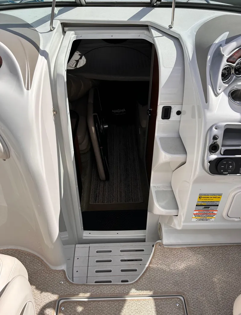 Slide: The Image of 2007 Crownline 255 CCR boat cabin entrance with control panel and seating area. - 37