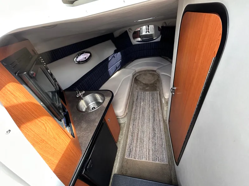 Slide: The Image of Interior of 2007 Crownline 255 CCR boat with kitchenette and seating area. - 38