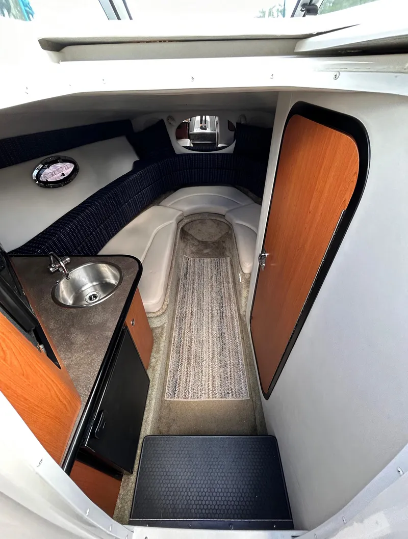 Slide: The Image of 2007 Crownline 255 CCR cabin interior with sink, seating, and storage. - 39