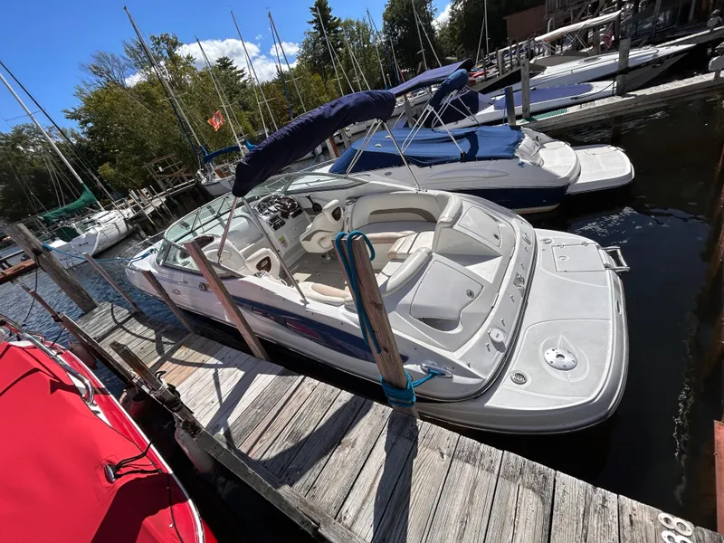 Slide: The Image of 2007 Crownline 255 CCR boat docked at marina, featuring sleek design and spacious seating. - 4