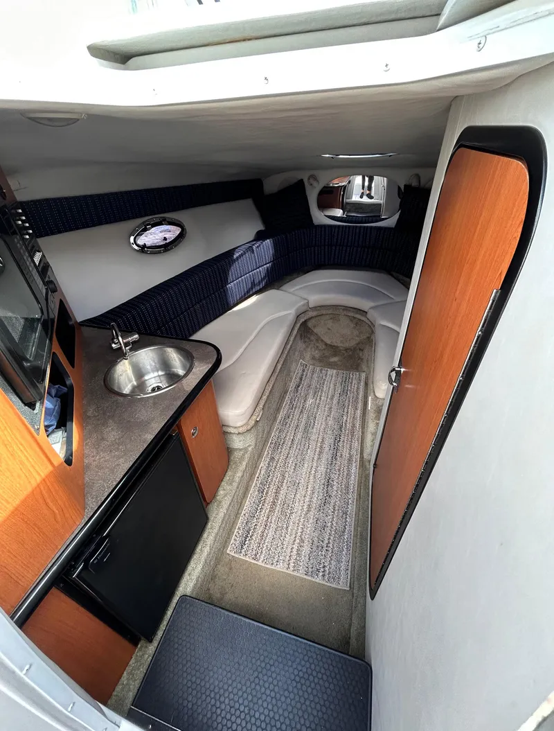 Slide: The Image of Interior of 2007 Crownline 255 CCR boat with kitchenette and seating area. - 40