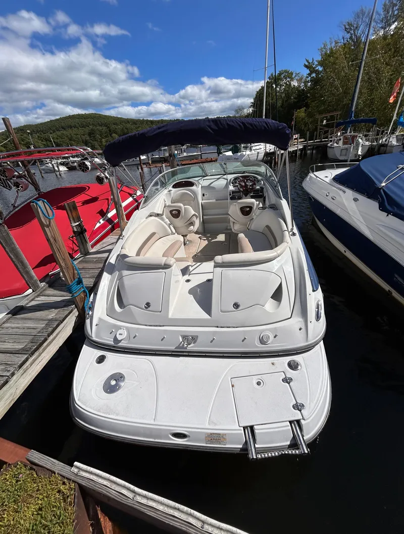 Slide: The Image of 2007 Crownline 255 CCR boat docked, featuring spacious seating and sleek design. - 5