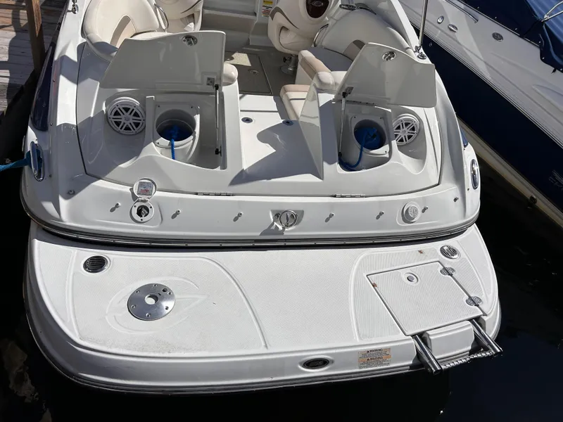 Slide: The Image of 2007 Crownline 255 CCR boat with open storage compartments and swim platform. - 7