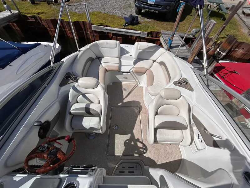 Slide: The Image of 2007 Crownline 255 CCR boat interior with plush seating and steering wheel. - 9