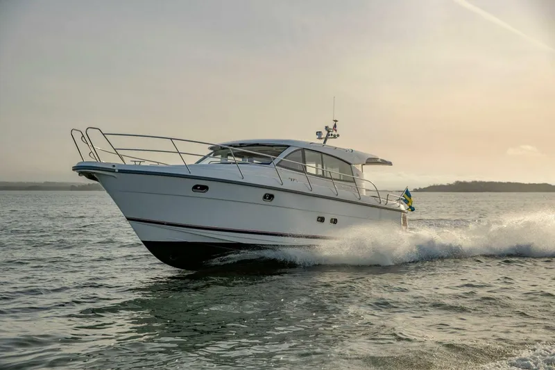 Slide: The Image of 2024 Nimbus 405 Coupé cruising on open water at sunset. - 0
