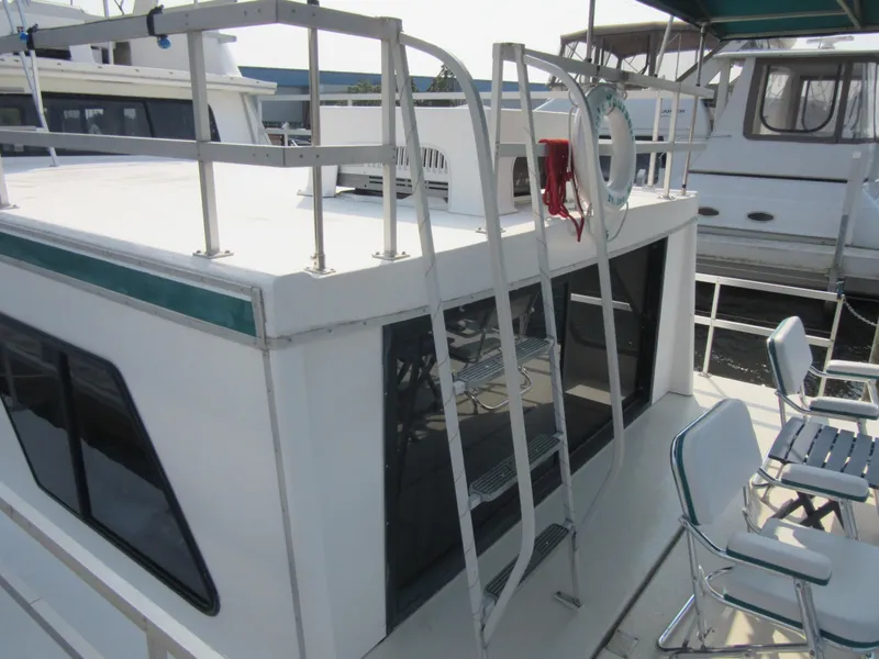 Slide: The Image of Gibson 44 Classic 1995 houseboat with upper deck and seating area. - 13