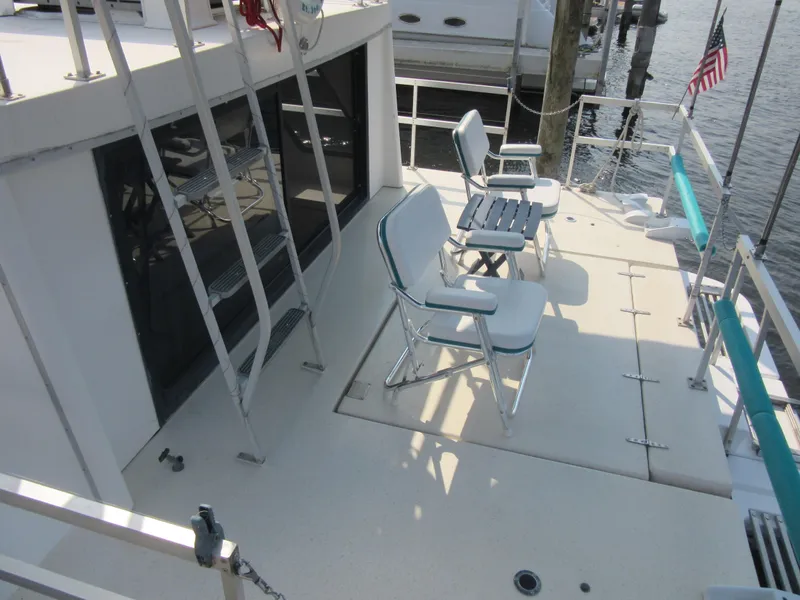 Slide: The Image of Deck of 1995 Gibson 44 Classic boat with chairs and table. - 16