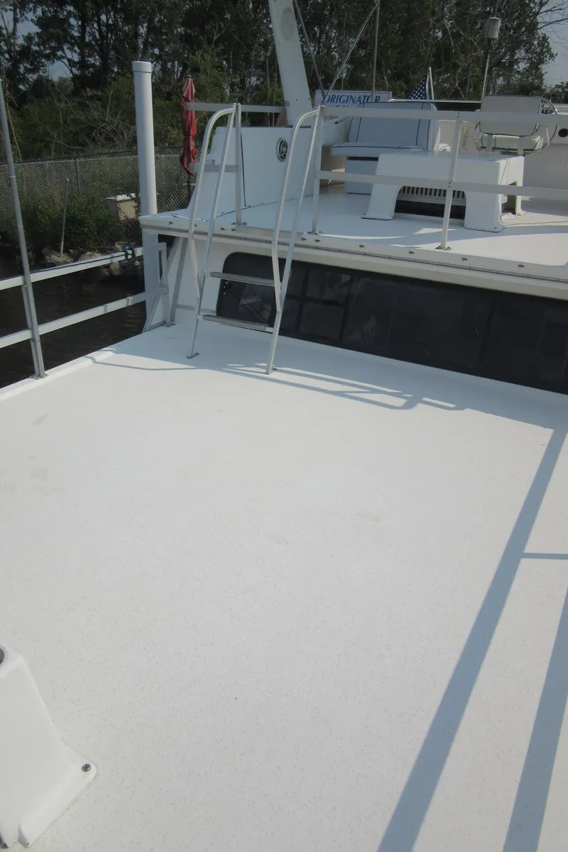 Slide: The Image of 1995 Gibson 44 Classic boat deck with ladder and railing. - 19