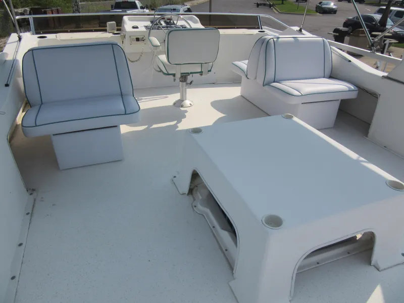 Slide: The Image of Spacious deck of 1995 Gibson 44 Classic boat with seating and helm. - 25
