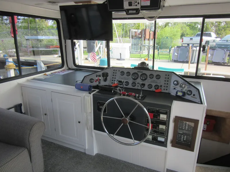 Slide: The Image of Interior helm of 1995 Gibson 44 Classic boat with steering wheel and control panel. - 26