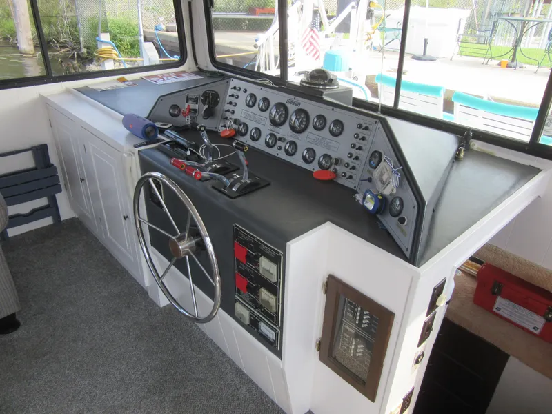 Slide: The Image of 1995 Gibson 44 Classic boat helm with steering wheel and control panel. - 29