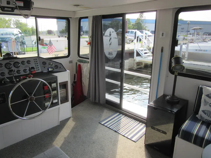 Slide: The Image of Interior of a 1995 Gibson 44 Classic boat with helm and marina view. - 30