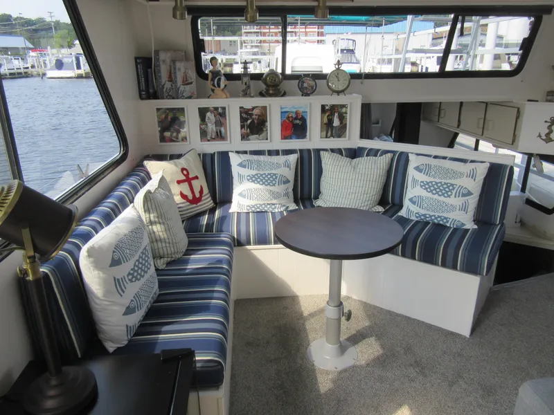 Slide: The Image of Cozy Gibson 44 Classic boat interior with striped seating and nautical decor, 1995 model. - 32