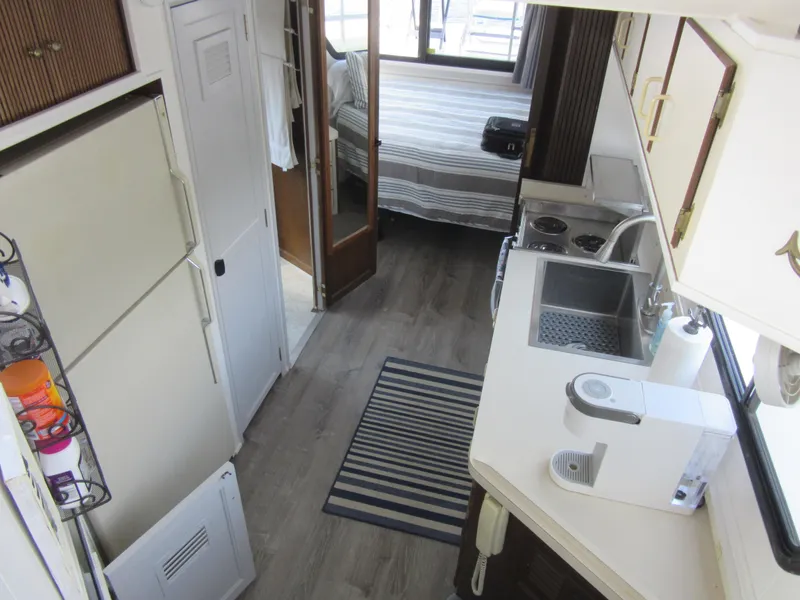 Slide: The Image of Interior of a 1995 Gibson 44 Classic boat with kitchen and bedroom. - 40