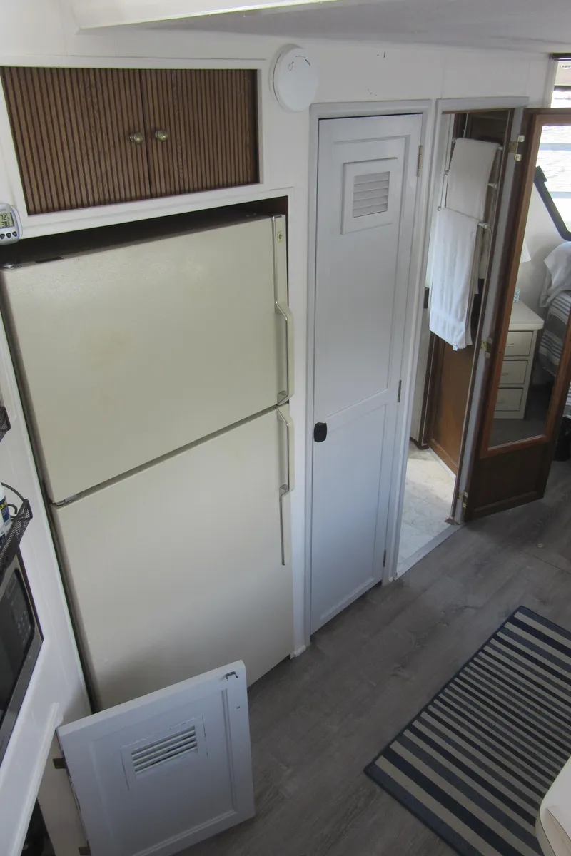 Slide: The Image of Interior of a 1995 Gibson 44 Classic boat with kitchen and hallway view. - 41