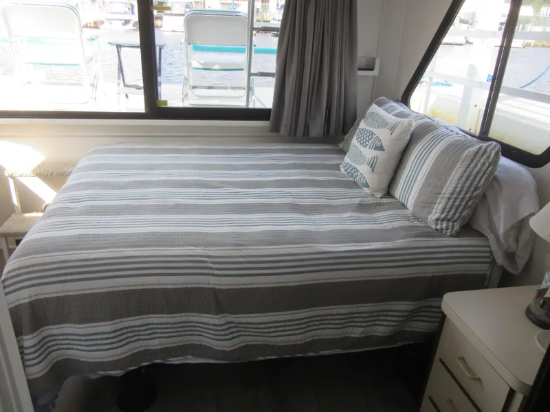 Slide: The Image of Cozy bedroom with striped bedding in a 1995 Gibson 44 Classic boat. - 43