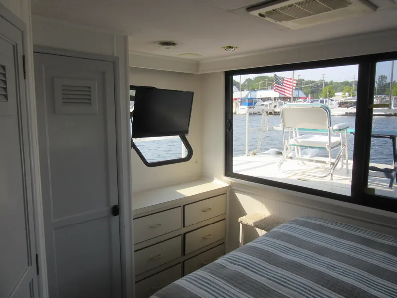 Slide: The Image of Interior of 1995 Gibson 44 Classic houseboat with window view of marina. - 44