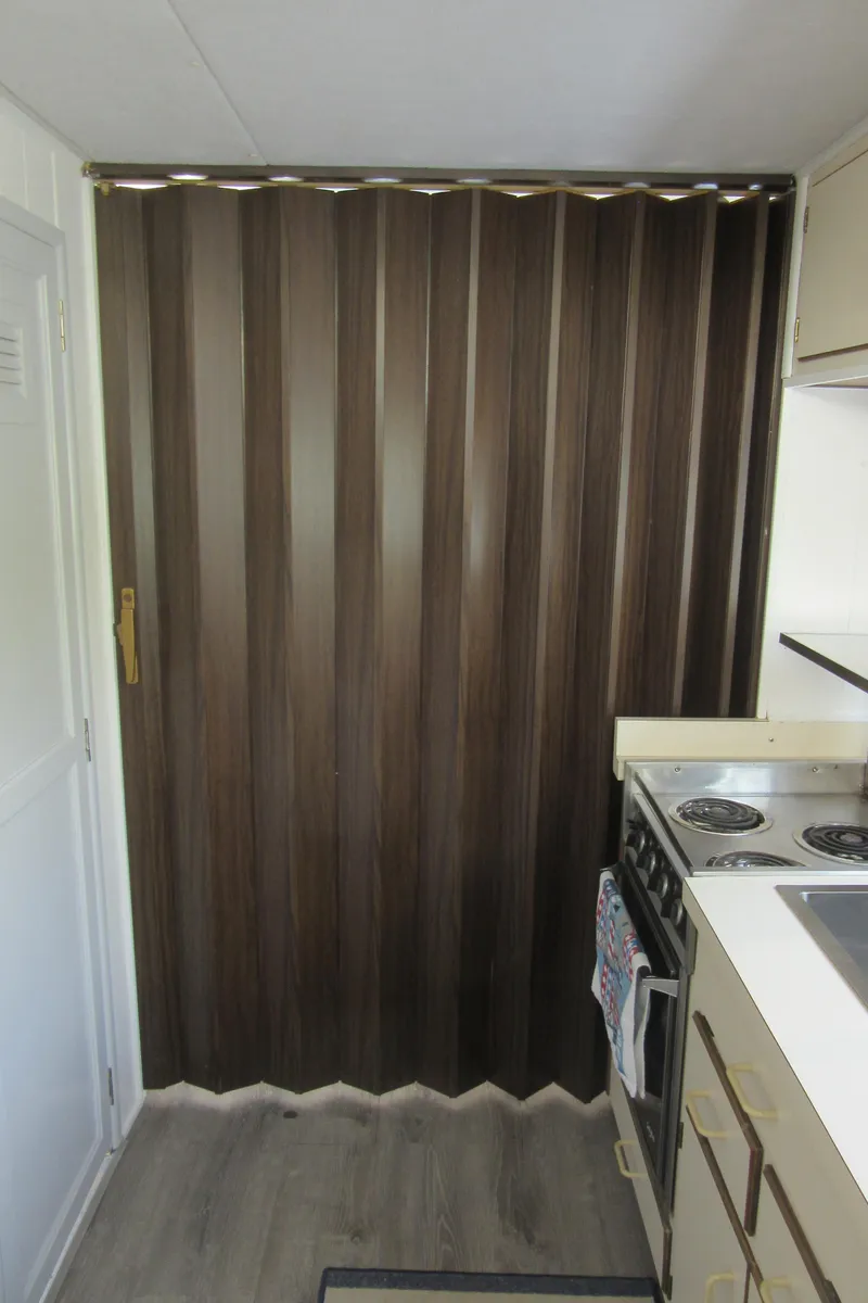 Slide: The Image of Accordion door in a compact kitchen with stove and cabinets, Gibson 44 Classic, 1995. - 46