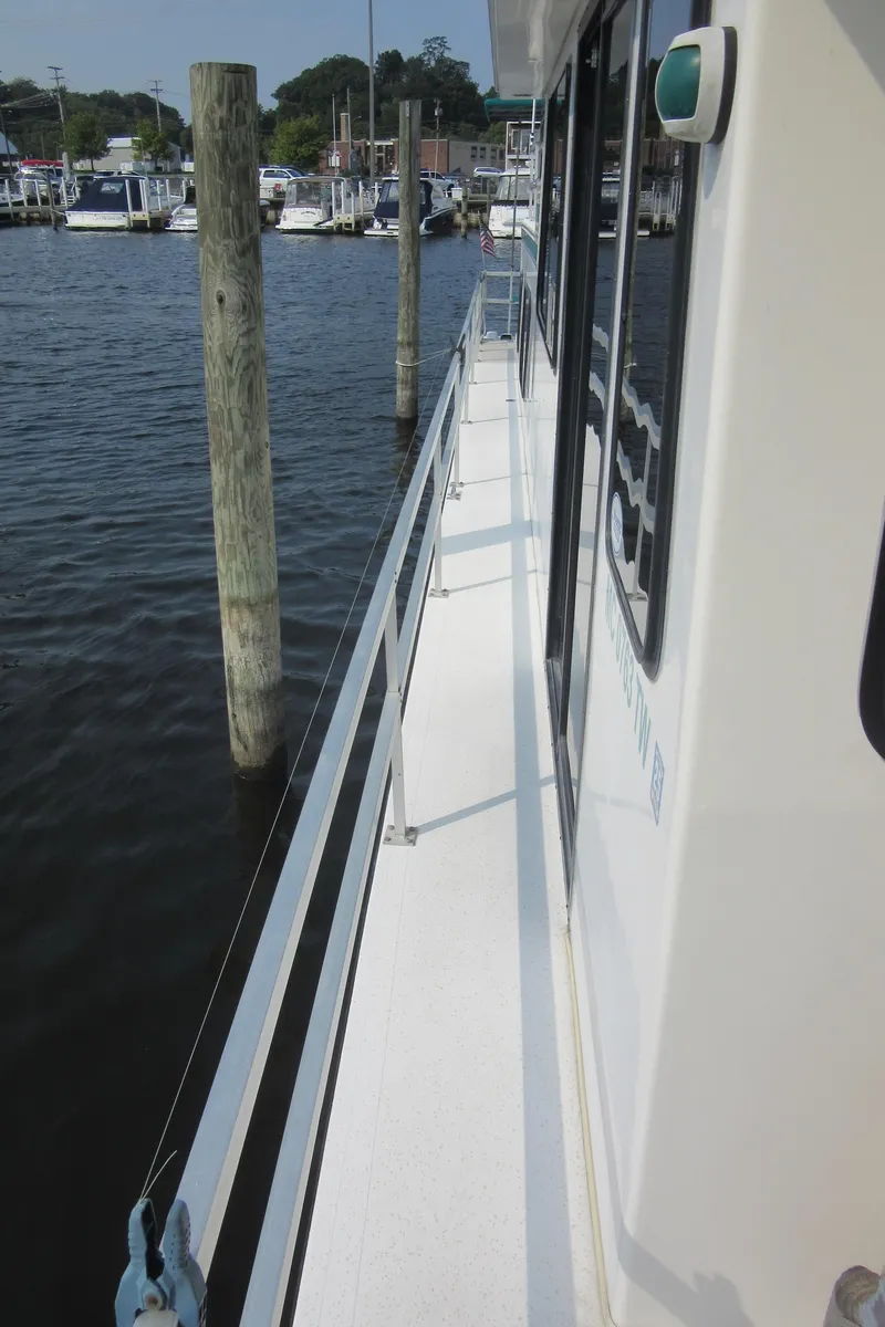 Slide: The Image of 1995 Gibson 44 Classic boat docked at marina, side view. - 9