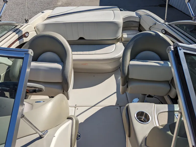 Slide: The Image of 2006 Sea Ray 200 Select boat interior with beige seating and cup holders. - 10