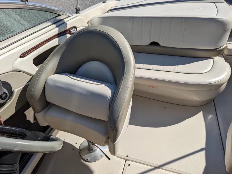 Slide: The Image of 2006 Sea Ray 200 Select boat interior with gray seating and steering wheel. - 11