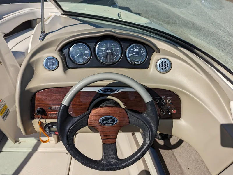 Slide: The Image of 2006 Sea Ray 200 Select boat dashboard with steering wheel and gauges. - 12