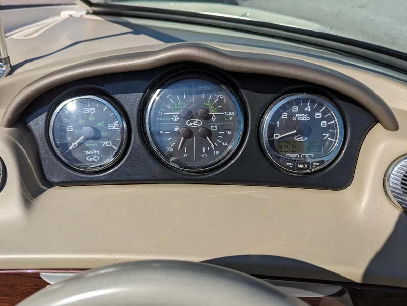 Slide: The Image of Dashboard gauges of a 2006 Sea Ray 200 Select boat. - 13
