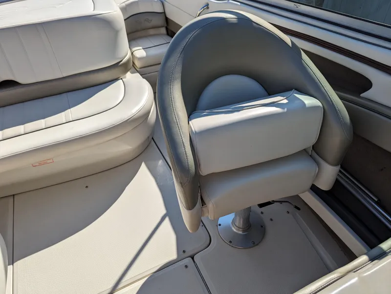 Slide: The Image of 2006 Sea Ray 200 Select boat interior with cushioned seating and helm chair. - 15