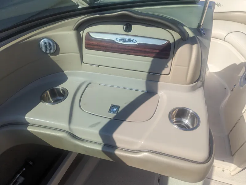 Slide: The Image of 2006 Sea Ray 200 Select boat interior with cup holders and storage compartment. - 16