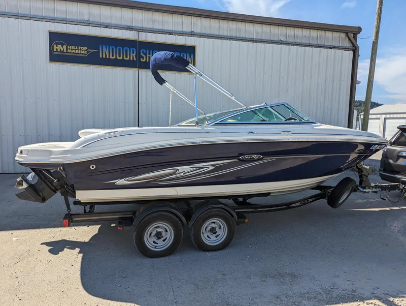 Slide: The Image of 2006 Sea Ray 200 Select boat on trailer outside showroom. - 2