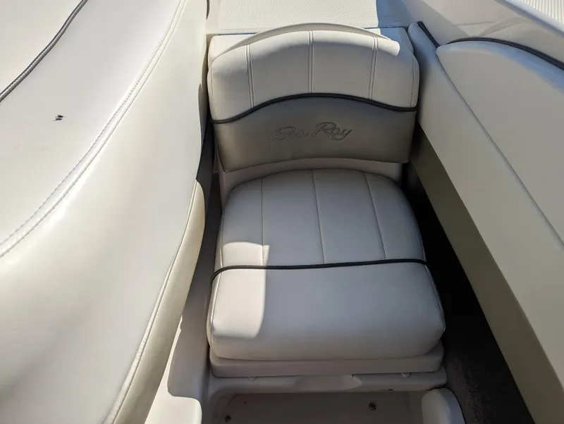 Slide: The Image of 2006 Sea Ray 200 Select boat seat with white upholstery and logo. - 23