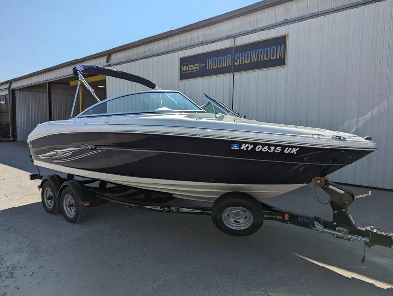 Slide: The Image of 2006 Sea Ray 200 Select boat on trailer outside showroom. - 3