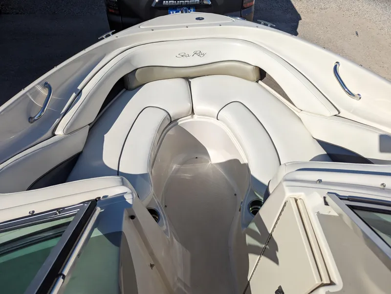 Slide: The Image of 2006 Sea Ray 200 Select boat interior with white seating and sleek design. - 7