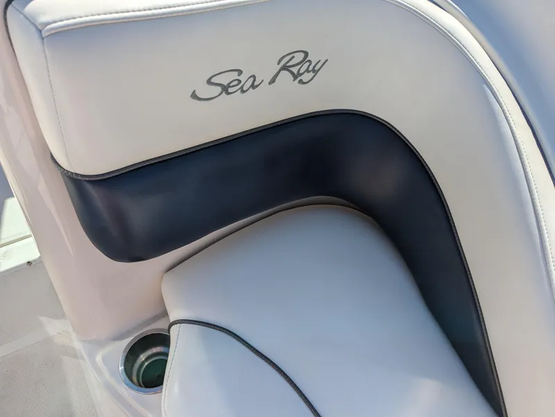 Slide: The Image of 2006 Sea Ray 200 Select boat interior with logo and sleek upholstery design. - 8