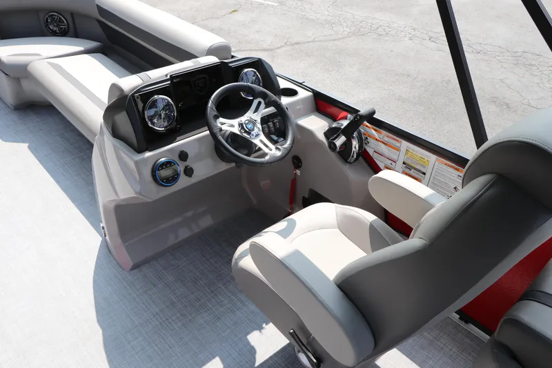 Slide: The Image of 2025 Premier 220 Sunscape boat interior with steering wheel and seating. - 11