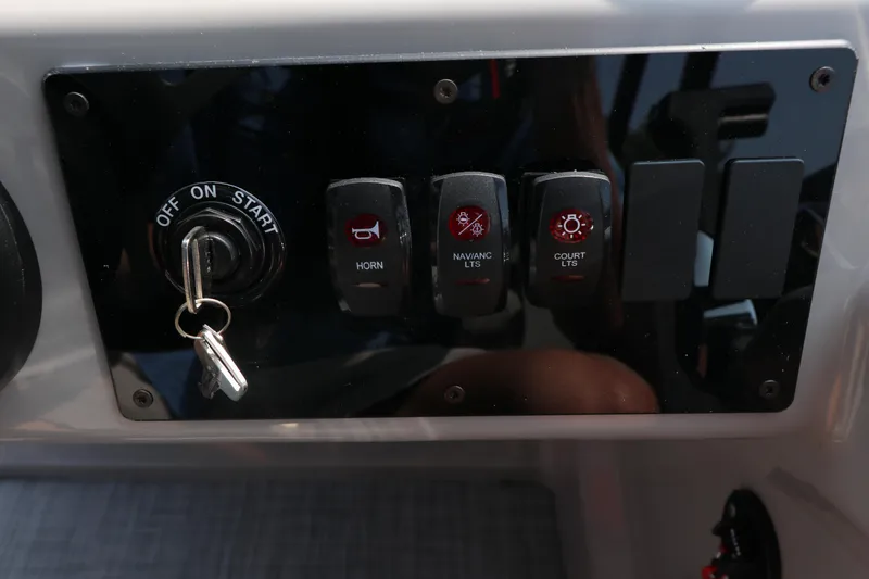 Slide: The Image of Control panel of 2025 Premier 220 Sunscape with ignition and switches. - 13