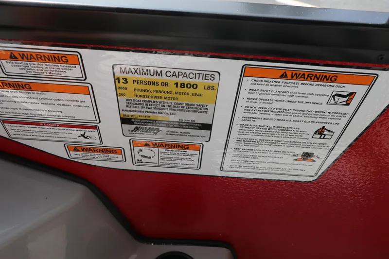 Slide: The Image of Warning labels on 2025 Premier 220 Sunscape boat, showing maximum capacity and safety instructions. - 16