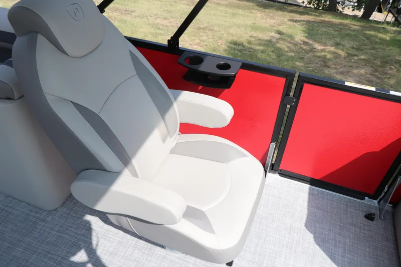 Slide: The Image of Luxurious seating in 2025 Premier 220 Sunscape boat with red paneling and cup holder. - 17