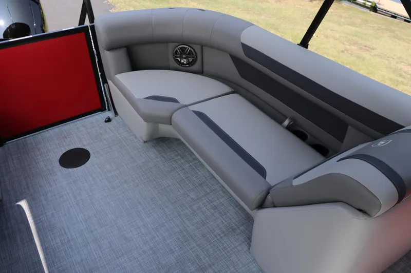 Slide: The Image of 2025 Premier 220 Sunscape boat interior with gray seating and speaker. - 18