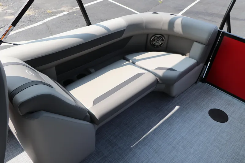 Slide: The Image of 2025 Premier 220 Sunscape boat interior with gray seating and speaker. - 20
