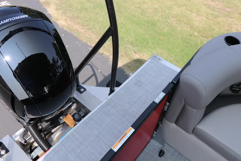 Slide: The Image of 2025 Premier 220 Sunscape boat interior with Mercury engine, gray seating, and deck. - 22