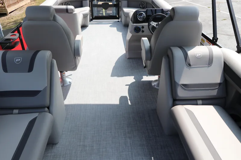 Slide: The Image of 2025 Premier 220 Sunscape boat interior with gray seating and modern dashboard. - 23