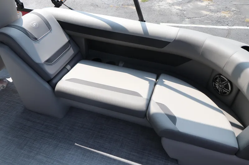 Slide: The Image of Premier 220 Sunscape 2025 boat interior with gray seating and speaker. - 24
